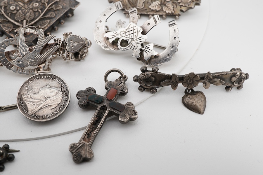 Ten assorted late 19th/early 20th century silver brooches, including three with names, Baby, Millicent and Ellen, together with five other white metal brooches including Scottish hardstones, a coin set stick pin, hardsto